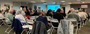 A large meeting room with rows of chairs