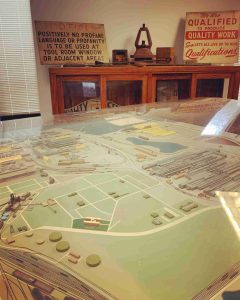 A large diorama and historic painted signs related to the steel industry