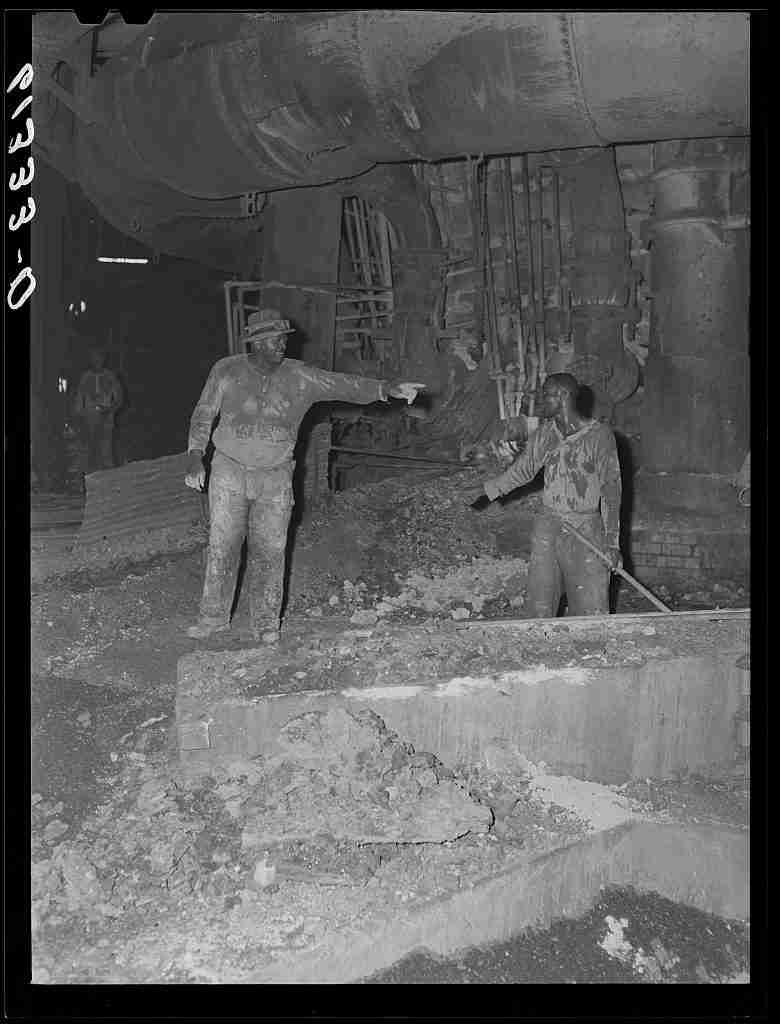 A black and white photo of two African American men working in the Sparrows Point mill