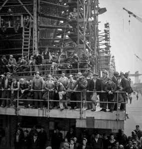 A 1943 photograph shows workers gathered to hear a speech.
