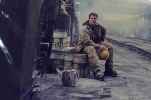A photo of the interviewee at the base of a crane