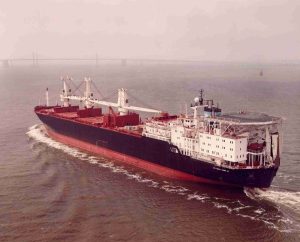 A color photograph shows a large container ship on the water