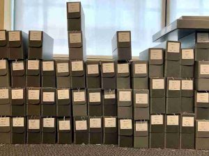 About 50 archival "clamshell" boxes, labeled and arranged in three tidy stacks, at the BMI's archives