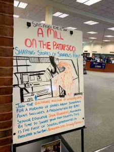 A hand-drawn sign on a whiteboard advertises a lecture offered by the BMI called, "A Mill on the Patapsco"